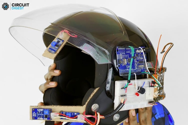 Complete assembled smart helmet transmitter showing all components mounted inside helmet including Arduino, sensors, and RF module with 17cm antenna